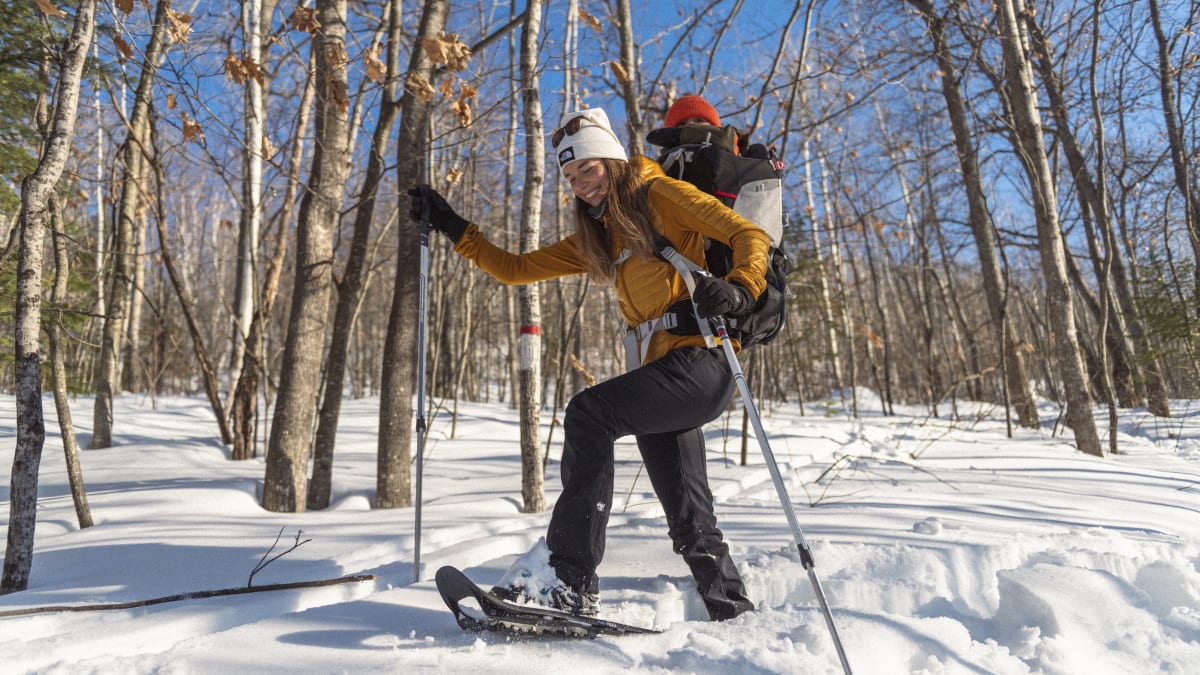 Young mother and baby on a snowshoeing trail