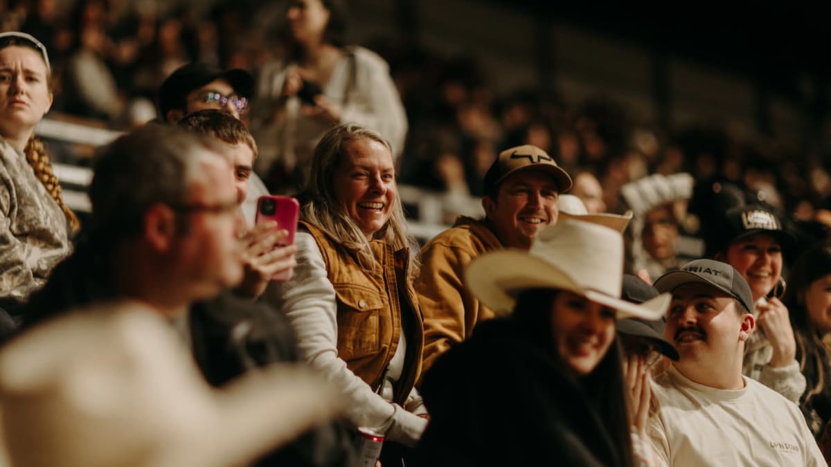 A crowd at the Saint-Tite Western Festival; a spectator wearing a cowboy hat is clearly visible in the foreground.
