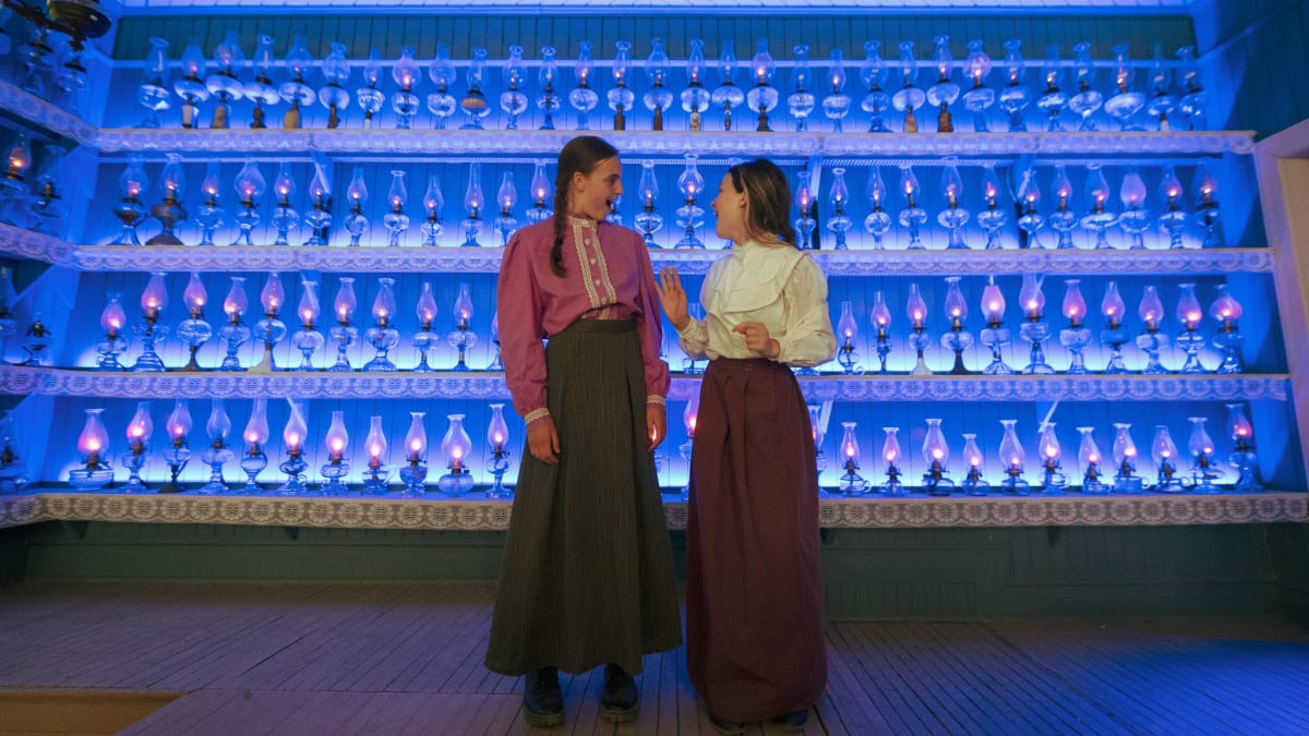 Two actresses in period costumes at the Village Québécois d'Antan.