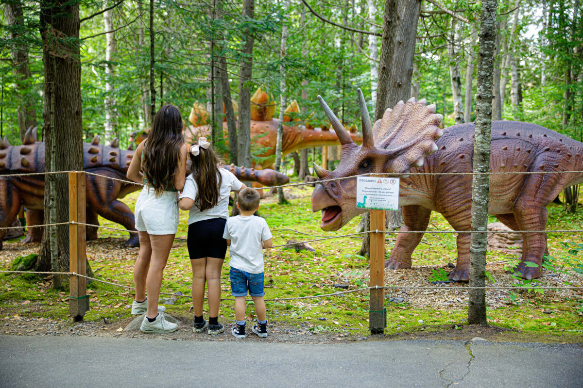 Famille devant des dinosaures grandeur nature
