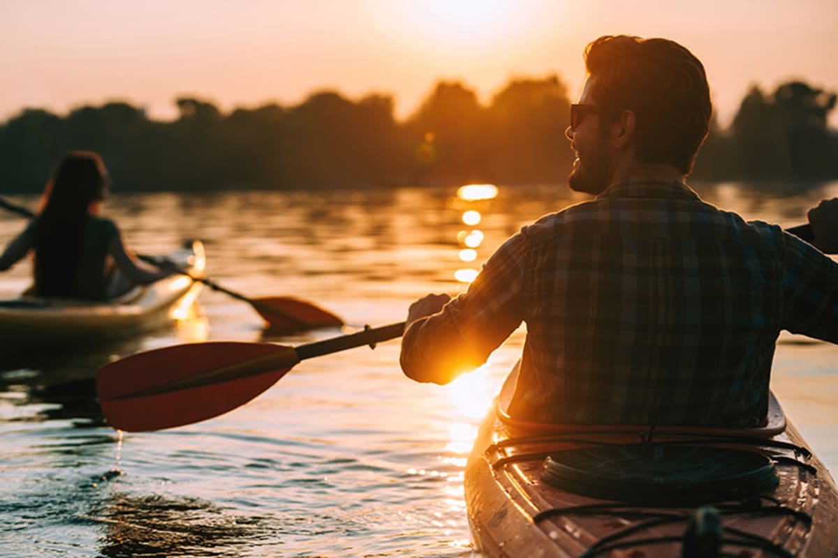 Couple kayaking at sunset