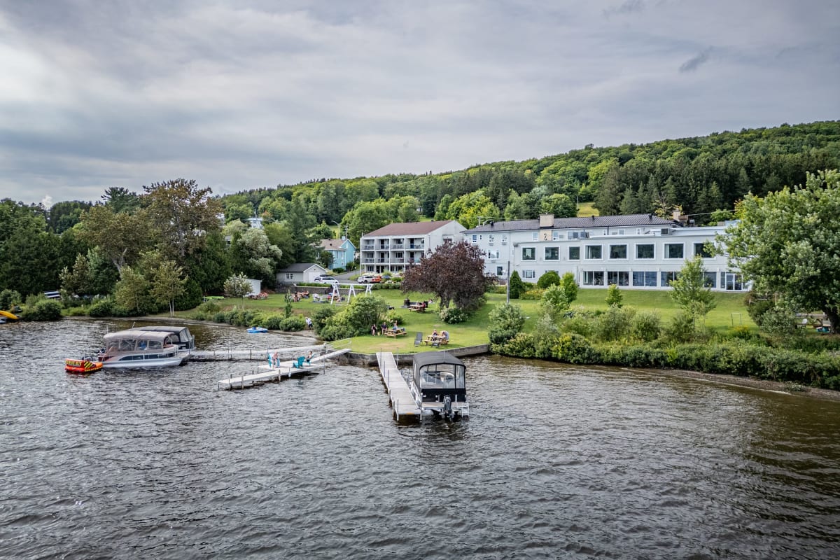 Lake Etchemin and the Manoir on its shores, with three docks and boats.