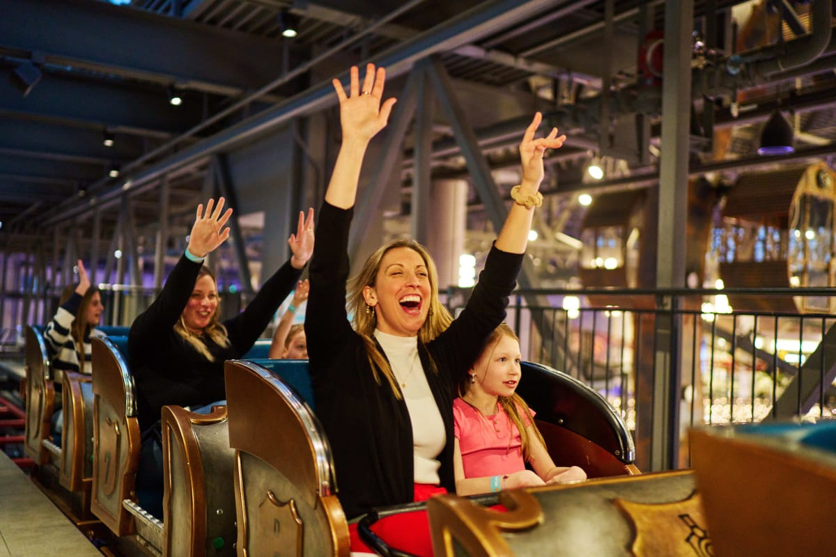 A mother and daughter at the start of a roller coaster.