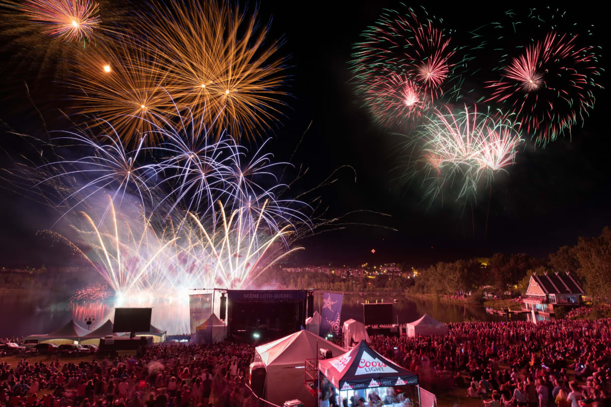 Fireworks over a crowd gathered for the Fête du Lac des Nations.