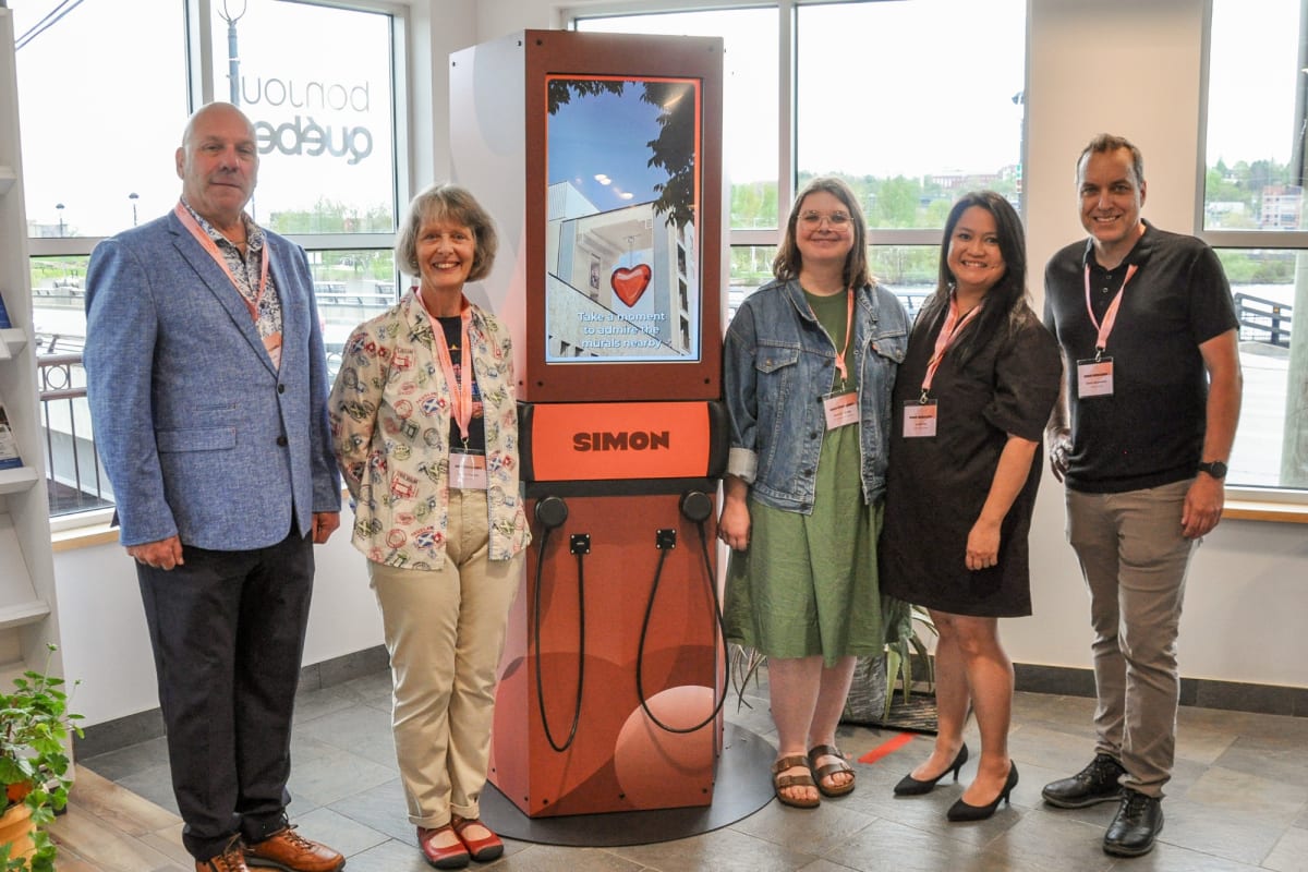 Urban Voices - 5 people standing next to an interactive kiosk.