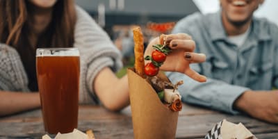 Couple à table avec bière et repas.
