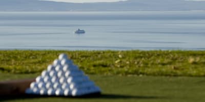 Golf ball in front of the river