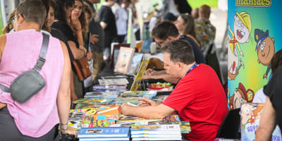 Prévost Comic Arts Festival - Cartoonists sitting at tables meet people