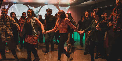 Val-d'Or Traditionnal Music Festival - People dance in a line, holding hands.