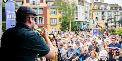 Musicien de trompette sur la scène et la foule le regardant.