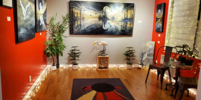 La Galerie de Miss Rey exposant des tableaux de paysages et d’oiseaux.