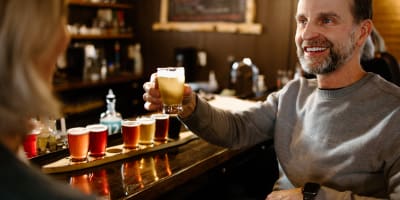 Man with a beers tasting flight at the Coureur des Bois microbrewery.