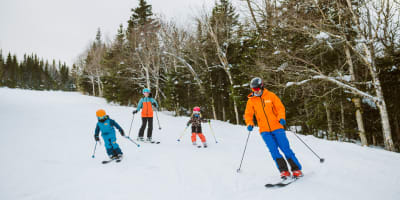 A family is skiing at Mont-Sainte-Anne.