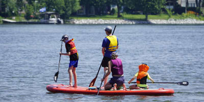 Family on a giant paddleboard.