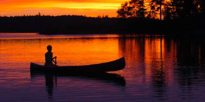 Fishing in a canoe at sunrise