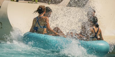 Une famille s'amuse à descendre une glissade au Super Aqua Club