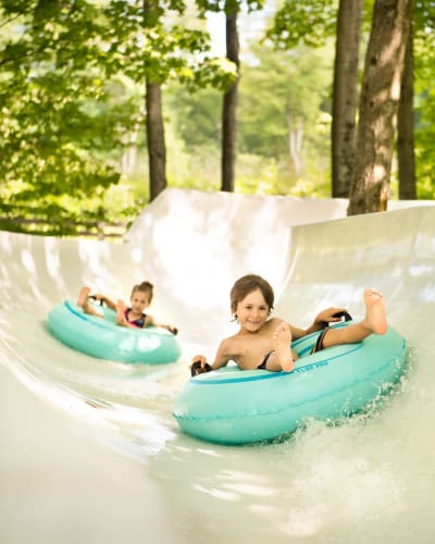 Children on tubes in a water slide.
