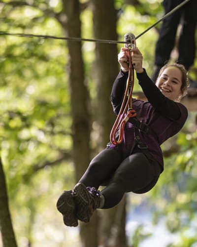 Teenage girl zip-lining