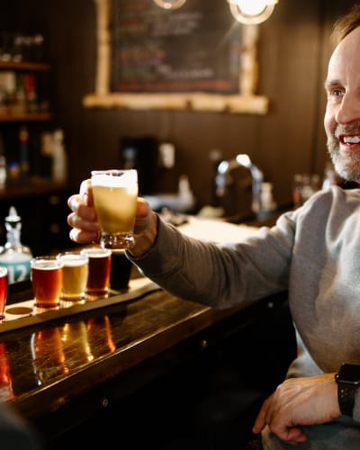 Man with a beers tasting flight at the Coureur des Bois microbrewery.