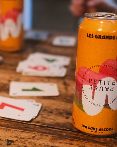 Microbrasserie Les Grands Bois - A bottle and cards on a wooden table