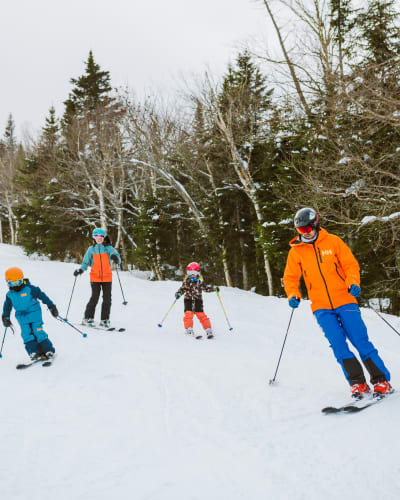 A family is skiing at Mont-Sainte-Anne.