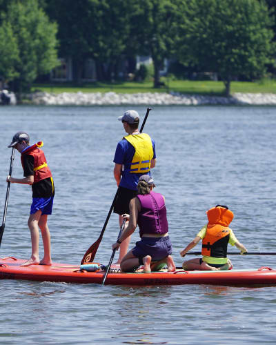 Family on a giant paddleboard.
