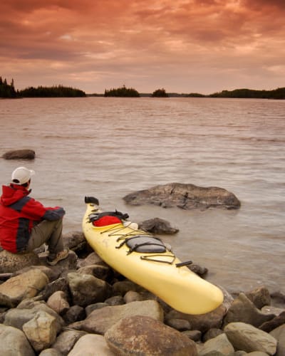 Kayaker on the shore of a lake in Aiguebelle National Park.