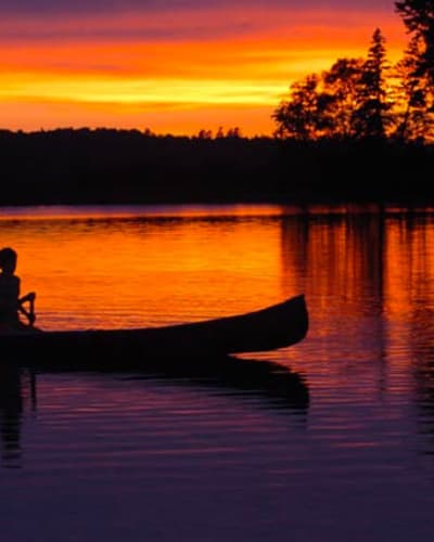 Fishing in a canoe at sunrise