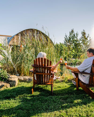 Vignoble de Pomone - A couple sitting on chairs outside