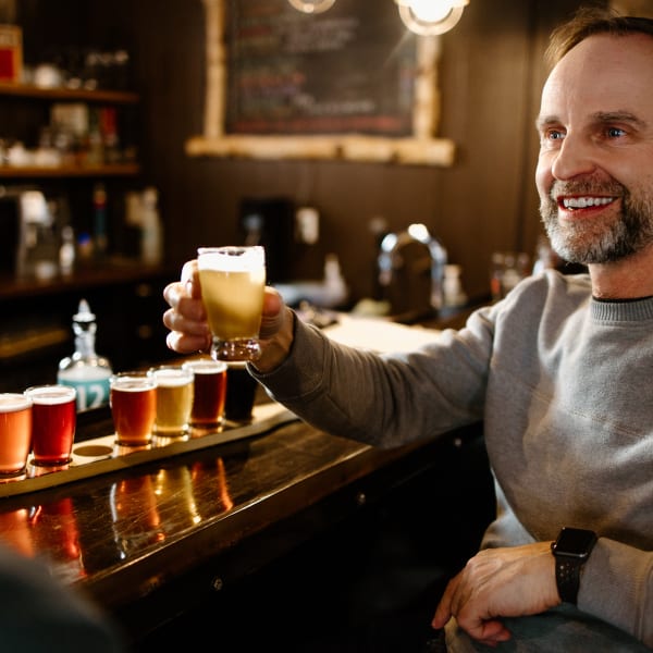 Man with a beers tasting flight at the Coureur des Bois microbrewery.
