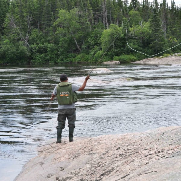 Salmon fishing in river, Pourvoirie Nabisipi Uenapeuhipu.