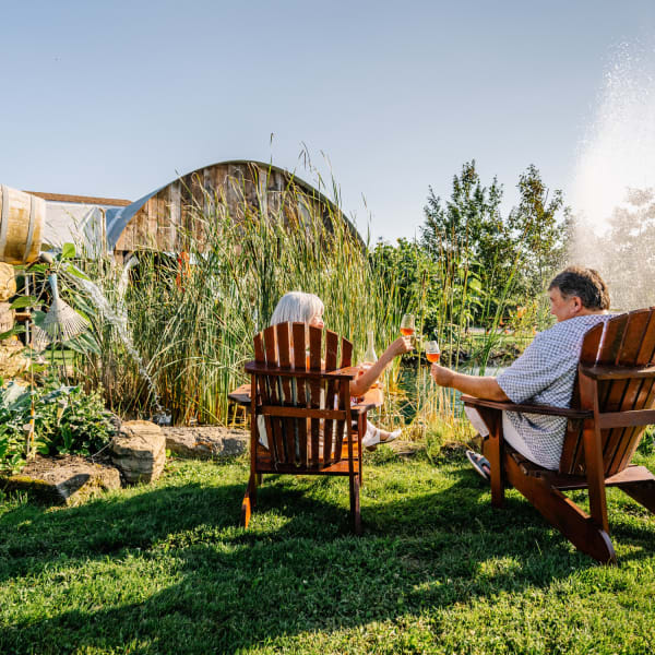 Vignoble de Pomone - A couple sitting on chairs outside