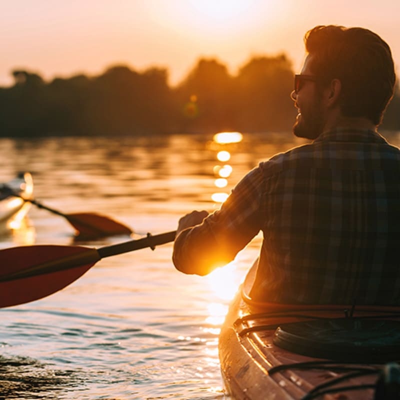 Couple kayaking at sunset