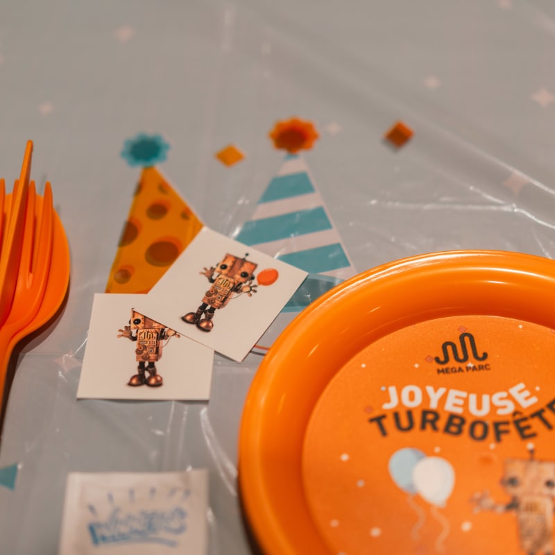 Utensils and plate for a kid's party.