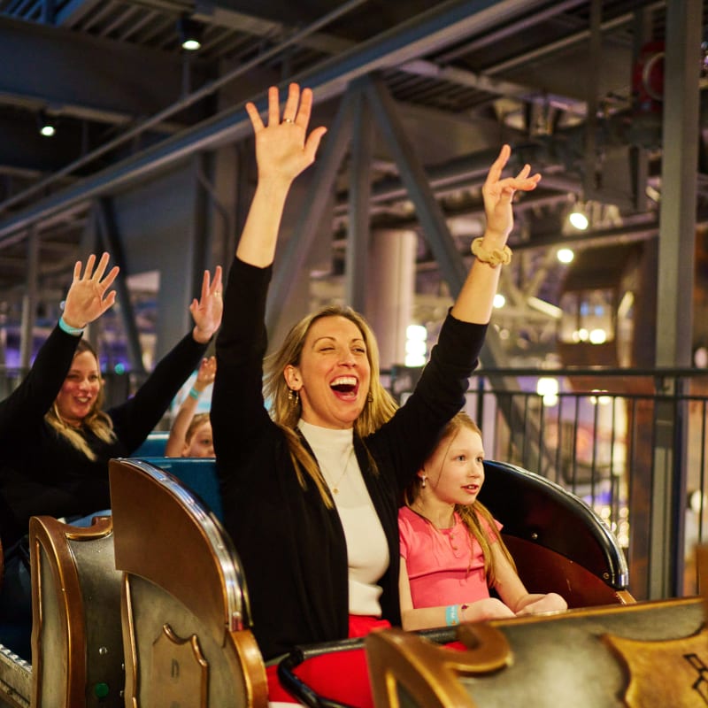 A mother and daughter at the start of a roller coaster.