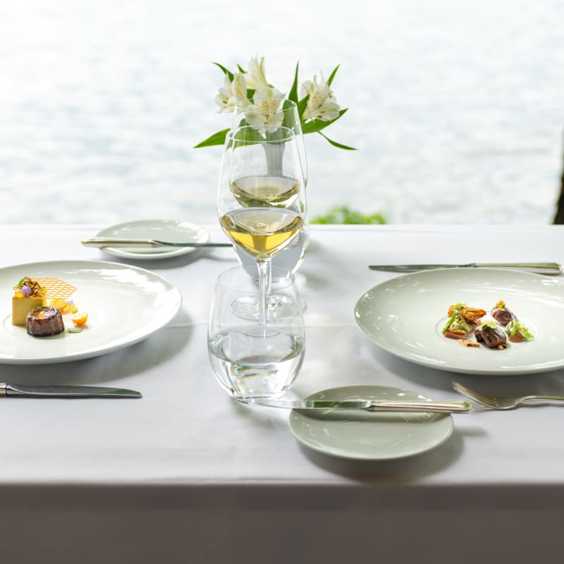 Table on the waterfront with two plates in the summer at the Ripplecove.