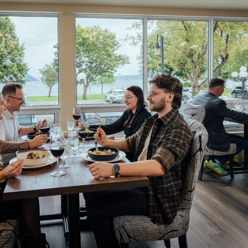 Four people enjoying a gourmet meal at Auberge des 21.
