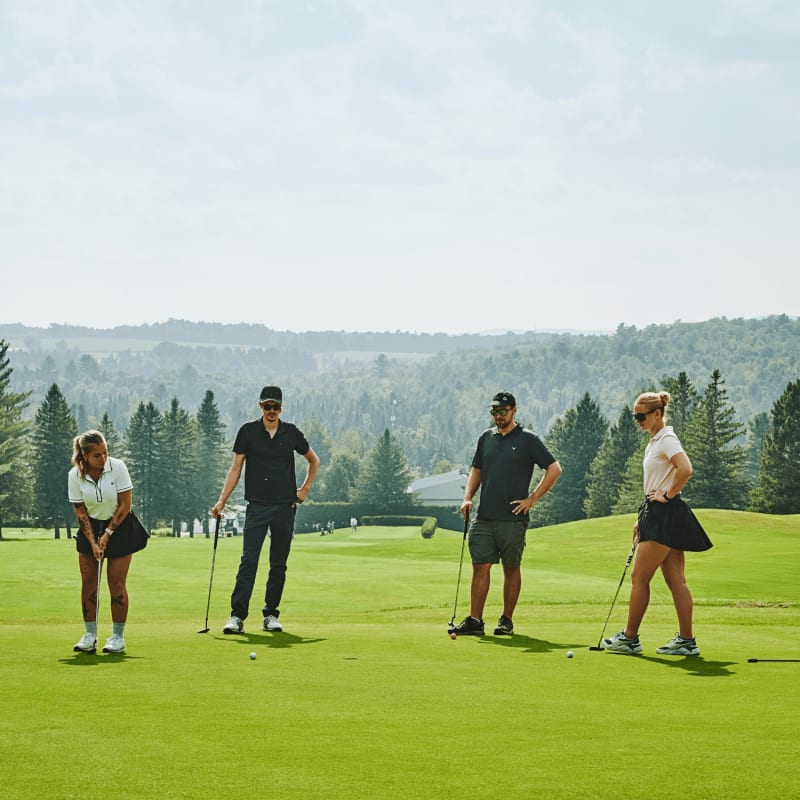 Four people on a green at the Milby Golf Club.