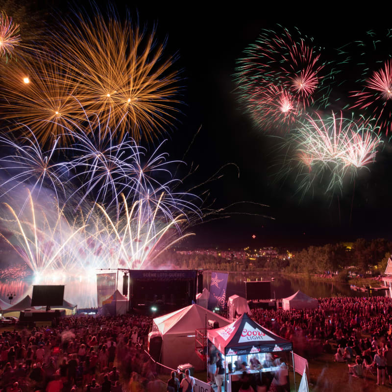 Fireworks over a crowd gathered for the Fête du Lac des Nations.